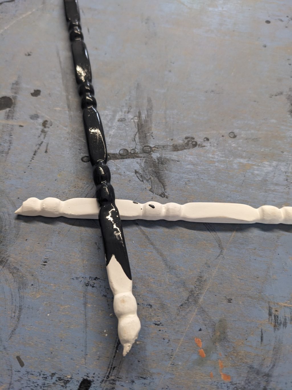 Sanding after painted in piano black White chalk base on wood carving, painted in piano black